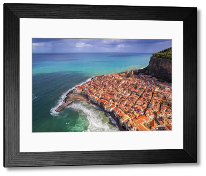 Framed Print : Aerial view of the historic centre of Cefalu with the rock in the background and red tile roofs, daytime, Cefalu, Palermo province, Tyrrhenian sea, Sicily, Italy Framed Print : Aerial view of the historic centre of Cefalu with the rock in the background and red tile roofs, daytime, Cefalu, Palermo province, Tyrrhenian sea, Sicily, Italy