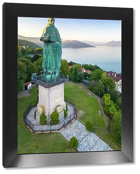 Aerial view of the Statue of San Carlo Borromeo during a summer sunset. Arona, Lake Maggiore, Piedmont, Italy