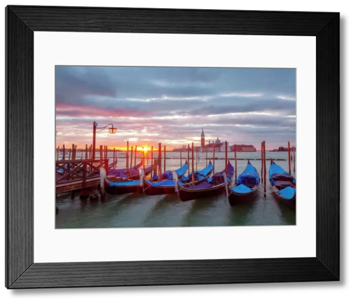 Framed Print : Some traditional venetian gondolas moored at Riva degli Schiavoni at dawn with St. george Island on the backgrund, Venice, Veneto, Italy