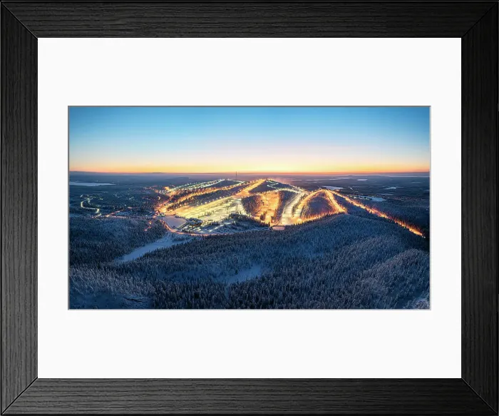Framed Print : Illuminated snowy ski slopes of Ruka ski resort surrounded by frozen forests at dusk, Lapland, Finland Framed Print : Illuminated snowy ski slopes of Ruka ski resort surrounded by frozen forests at dusk, Lapland, Finland