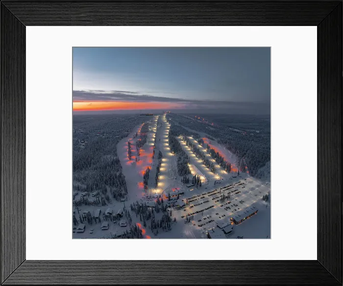 Framed Print : Panoramic aerial view of people skiing on the snowy ski slopes of Iso Syote winter resort at dusk, Pudasjarvi, Lapland, Finland