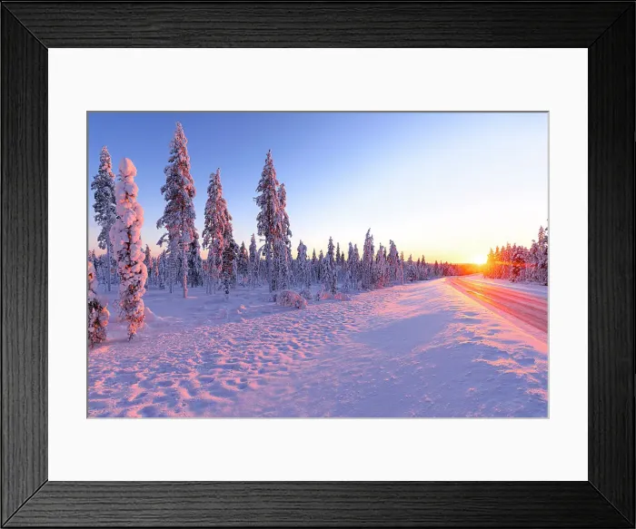 Framed Print : Icy road in the snowy forest brightly lit by the ethereal warm lights of the arctic sunset, Iso Syote, Lapland, Finland Framed Print : Icy road in the snowy forest brightly lit by the ethereal warm lights of the arctic sunset, Iso Syote, Lapland, Finland
