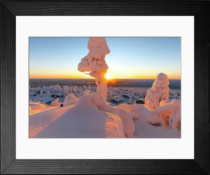 Framed Print : Frozen trees framing the snowy cottages in the winter landscape of Finnish Lapland at dawn Framed Print : Frozen trees framing the snowy cottages in the winter landscape of Finnish Lapland at dawn