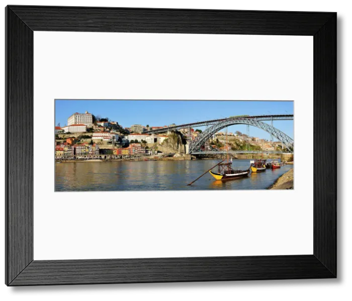 Framed Print : Oporto, capital of the Port wine and the Douro river. The bridge Dom Luis, a UNESCO World Heritage Site. In the foreground the traditional boats called Rabelos'. Portugal Framed Print : Oporto, capital of the Port wine and the Douro river. The bridge Dom Luis, a UNESCO World Heritage Site. In the foreground the traditional boats called Rabelos'. Portugal