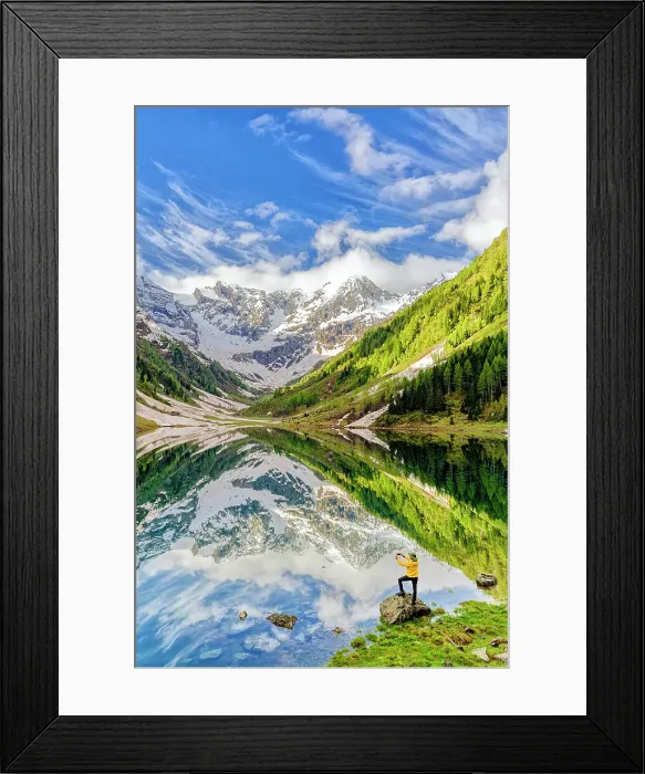 Framed Print : Man photographing mountains reflected in lake with smartphone standing on rocks, Valtellina, Lombardy, Italy Framed Print : Man photographing mountains reflected in lake with smartphone standing on rocks, Valtellina, Lombardy, Italy
