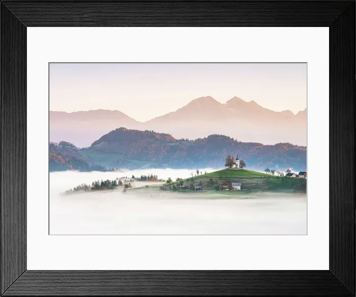 Framed Print : Church of St. Thomas and the Kamink Savinja Alps in winter, Skofja Loka, Slovenia