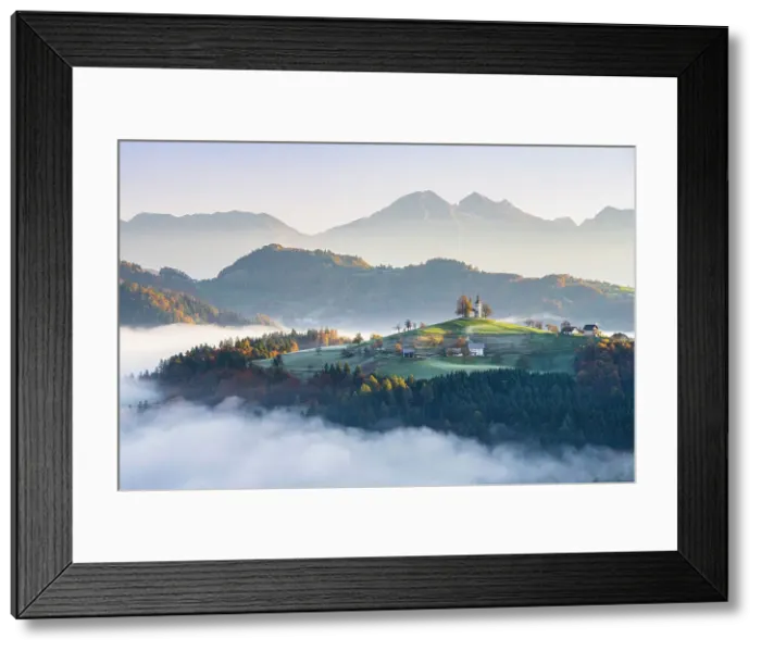 Framed Print : Church of St. Thomas and the Kamink Savinja Alps in winter, Skofja Loka, Slovenia