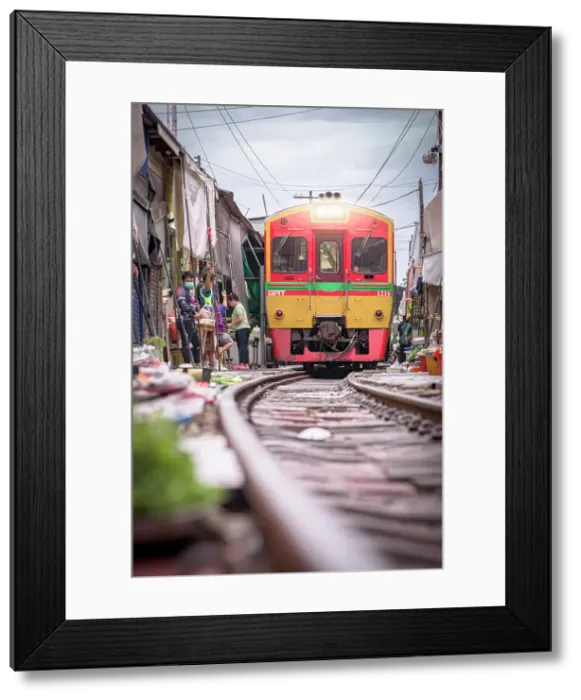 Framed Print : Train approaching at Mae Klong Railway market, Samut Songkhram province, Bangkok, Thailand