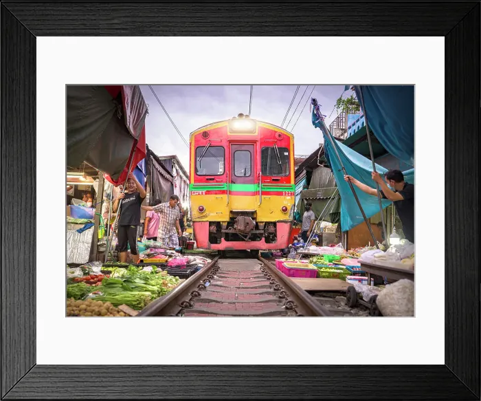 Framed Print : Sellers fast picking up wares just before train passing at Maeklong Railway market, Samut Songkhram province, Bangkok, Thailand