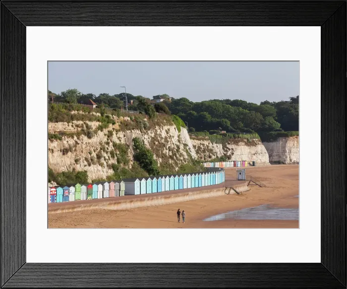 Framed Print : England, Kent, Broadstairs, Stone Bay, Long Row of Colourful Beach Huts and Dog Walker Framed Print : England, Kent, Broadstairs, Stone Bay, Long Row of Colourful Beach Huts and Dog Walker