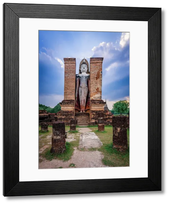 Framed Print : The iconic standing Buddha 12 Meter tall (Phra Attharot), Wat Mahathat temple, Sukhothai Historical Park, Sukhothai, Thailand Framed Print : The iconic standing Buddha 12 Meter tall (Phra Attharot), Wat Mahathat temple, Sukhothai Historical Park, Sukhothai, Thailand