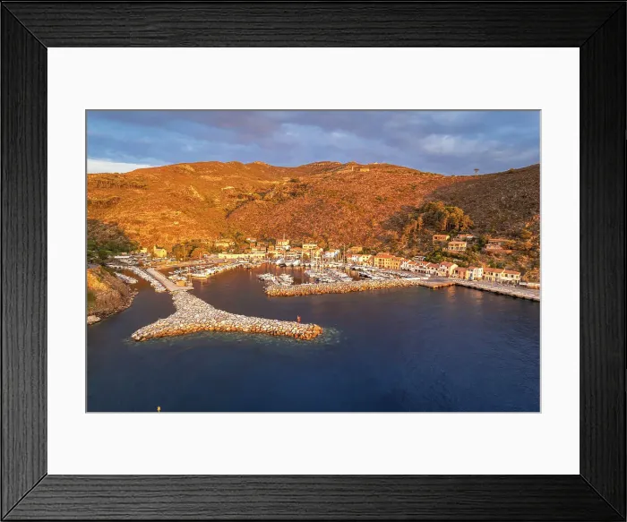 Framed Print : View of the marina of Capraia island at sunrise, aerial view, Tuscan Archipelago National Park, Livorno province, Tuscany, Italy Framed Print : View of the marina of Capraia island at sunrise, aerial view, Tuscan Archipelago National Park, Livorno province, Tuscany, Italy