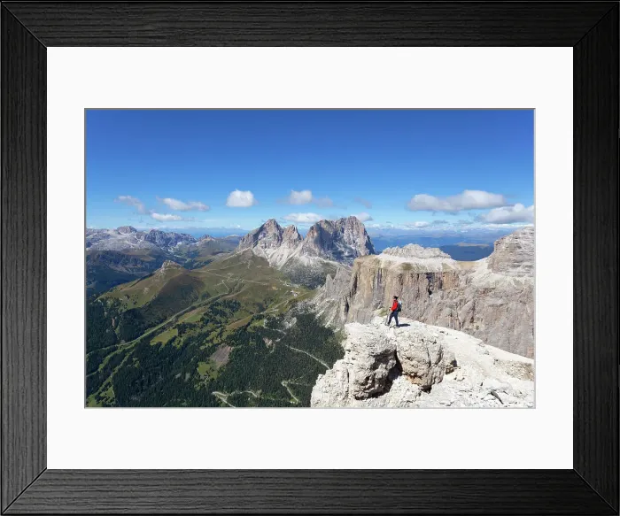 Framed Print : A hiker admires Fassa Valley and Sassolungo Group from Sass Pordoi, Sella Group, Dolomites, Canazei, Trentino - Alto Adige, Italy. (MR) Framed Print : A hiker admires Fassa Valley and Sassolungo Group from Sass Pordoi, Sella Group, Dolomites, Canazei, Trentino - Alto Adige, Italy. (MR)