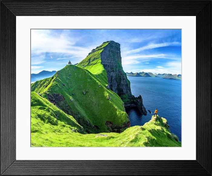 Framed Print : Hiker looking at Kallur lighthouse standing on green cliffs, Kalsoy island, Faroe Islands, Denmark Framed Print : Hiker looking at Kallur lighthouse standing on green cliffs, Kalsoy island, Faroe Islands, Denmark