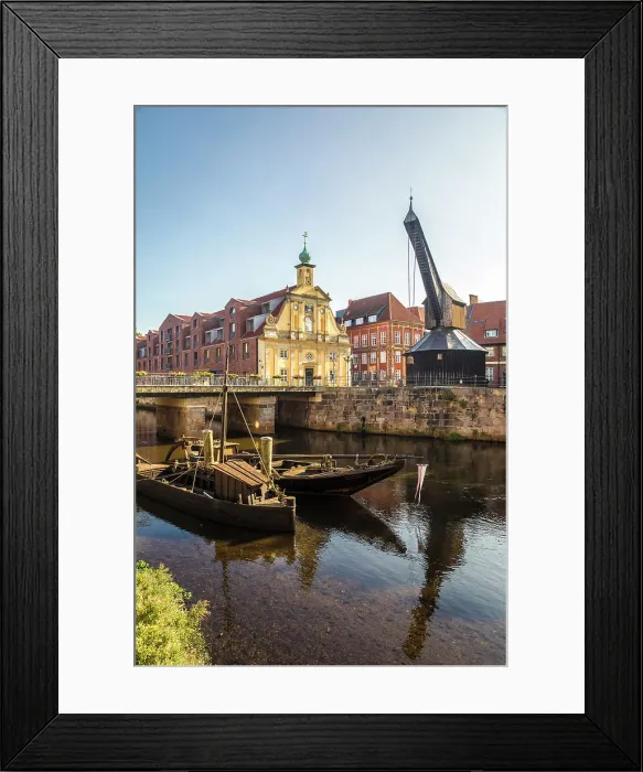 Framed Print : Old barges on the Ilmenau with old department store, Luneburg, Lower Saxony, Germany Framed Print : Old barges on the Ilmenau with old department store, Luneburg, Lower Saxony, Germany