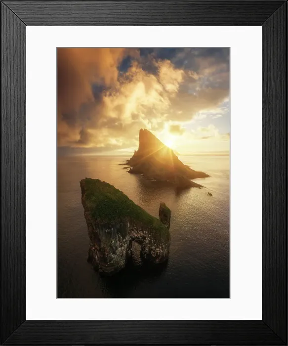 Framed Print : Aerial view of a colorful sunset behind the cliffs of Drangarnir after the storm cleared. Vagar, Faroe Islands Framed Print : Aerial view of a colorful sunset behind the cliffs of Drangarnir after the storm cleared. Vagar, Faroe Islands