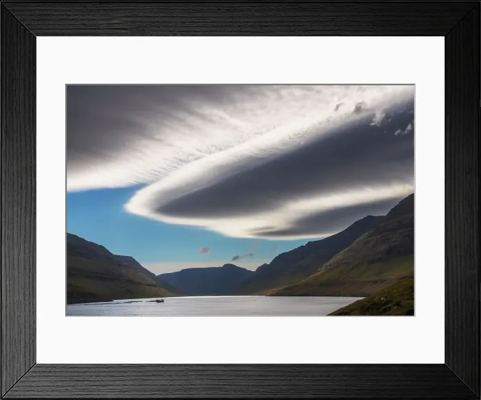 Framed Print : Lenticular clouds hovering over a fjord in the island of Vidoy, in the northern part of the Faroe Islands archipelago Framed Print : Lenticular clouds hovering over a fjord in the island of Vidoy, in the northern part of the Faroe Islands archipelago