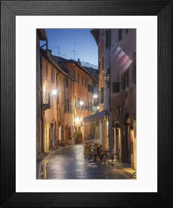Framed Print : Twilight street view of San Quirico d'Orcia during a rainy winter evening in Val d'Orcia, Tuscany, Italy Framed Print : Twilight street view of San Quirico d'Orcia during a rainy winter evening in Val d'Orcia, Tuscany, Italy