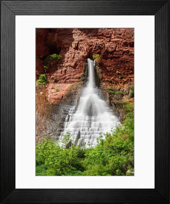 Framed Print : A waterfall pouring out of sandstone walls near the Colorado River, Grand Canyon National Park, Arizona, USA