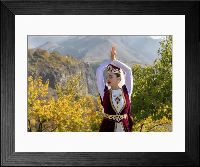 Framed Print : A woman dressed in traditional costume dances at Garni temple, Armenia Framed Print : A woman dressed in traditional costume dances at Garni temple, Armenia