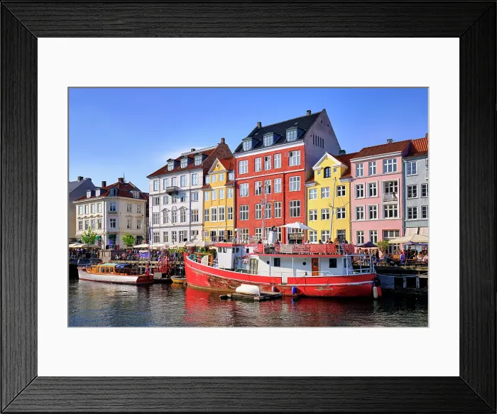 Framed Print : Nyhavn, or New Harbour, is a 17th-century waterfront, canal and entertainment district, full of restaurants and bars, in Copenhagen, Denmark Framed Print : Nyhavn, or New Harbour, is a 17th-century waterfront, canal and entertainment district, full of restaurants and bars, in Copenhagen, Denmark