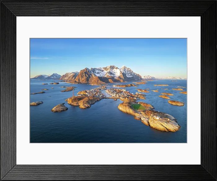 Framed Print : Henningsvaer with snowy massif in the background seen from the drone at sunset, Vagan, Austvagoy, Nordland, Lofoten, Norway, Northern Europe, Scandinavia, Europe