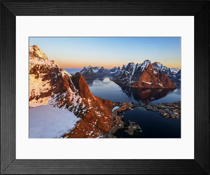 Framed Print : Aerial view at sunset over the rugged snowy peaks and the bay of Reine in winter, Moskenes, Lofoten Islands, Norway Framed Print : Aerial view at sunset over the rugged snowy peaks and the bay of Reine in winter, Moskenes, Lofoten Islands, Norway