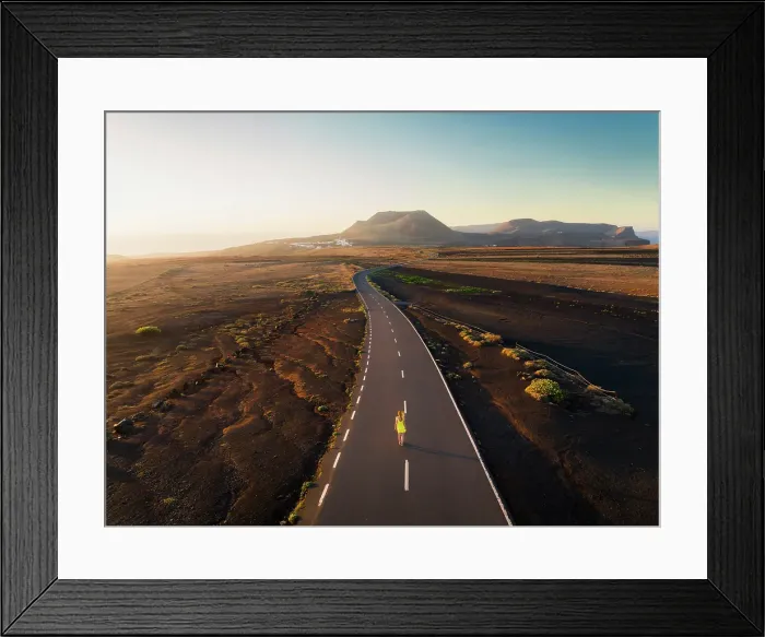 Framed Print : A tourist walks along the road that leads to the crater of Volcan de la Corona during sunrise, Mirador del Rio, Haria, Las Palmas, Lanzarote, Canary Islands, Spain Framed Print : A tourist walks along the road that leads to the crater of Volcan de la Corona during sunrise, Mirador del Rio, Haria, Las Palmas, Lanzarote, Canary Islands, Spain