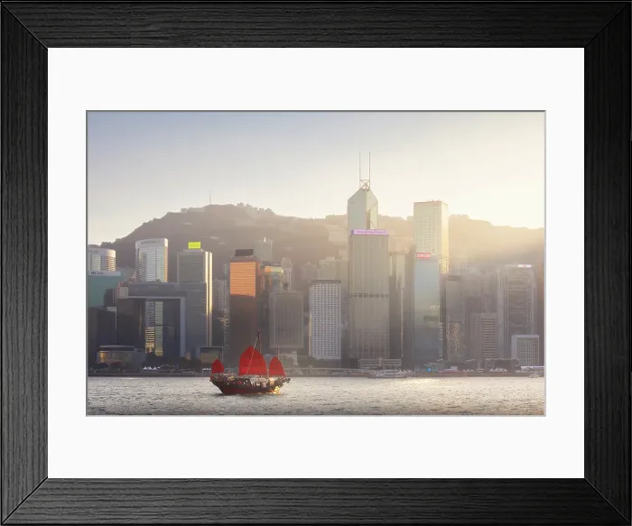 Framed Print : Ancient Dunkling boat sails in front of cityscape of Hong Kong during sunset, Tsim Sha Tsui, Kowloon, Hong Kong, China, Asia Framed Print : Ancient Dunkling boat sails in front of cityscape of Hong Kong during sunset, Tsim Sha Tsui, Kowloon, Hong Kong, China, Asia