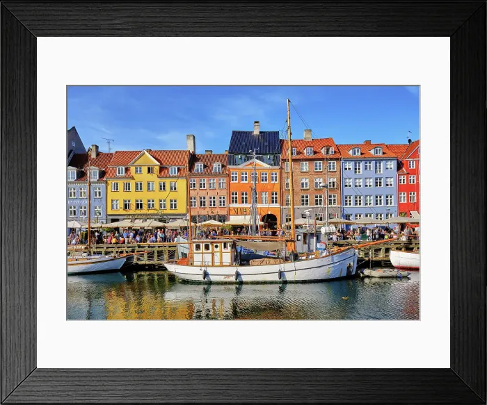 Framed Print : Nyhavn, or New Harbour, is a 17th-century waterfront, canal and entertainment district, full of restaurants and bars, in Copenhagen, Denmark Framed Print : Nyhavn, or New Harbour, is a 17th-century waterfront, canal and entertainment district, full of restaurants and bars, in Copenhagen, Denmark