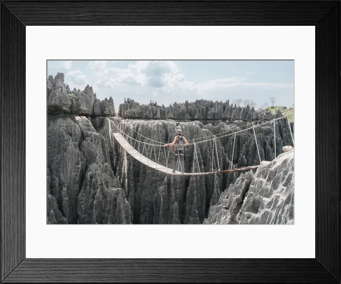 Framed Print : Hiker crosses a rope bridge. Madagascar, Africa. Tsingy De Bemaraha Framed Print : Hiker crosses a rope bridge. Madagascar, Africa. Tsingy De Bemaraha