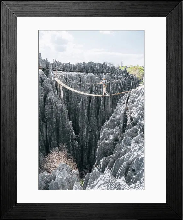 Framed Print : Hiker crosses a rope bridge. Madagascar, Africa. Tsingy De Bemaraha Framed Print : Hiker crosses a rope bridge. Madagascar, Africa. Tsingy De Bemaraha