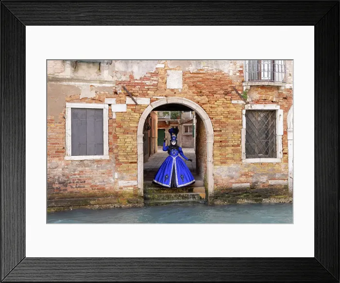 Framed Print : A woman in a blue costume stands by a canal during the Venice Carnival, Venice, Italy Framed Print : A woman in a blue costume stands by a canal during the Venice Carnival, Venice, Italy