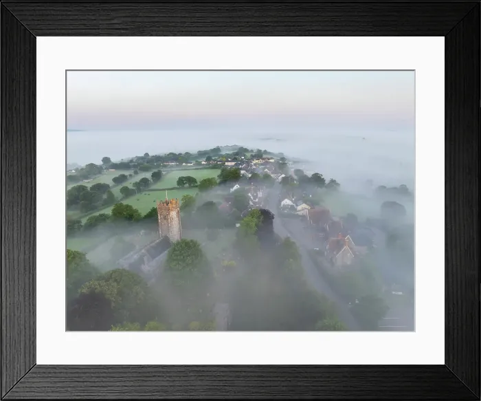Framed Print : St Mary's Church and village emerging from morning mist at sunrise, Morchard Bishop, Devon, England. Summer (July) 2024 Framed Print : St Mary's Church and village emerging from morning mist at sunrise, Morchard Bishop, Devon, England. Summer (July) 2024