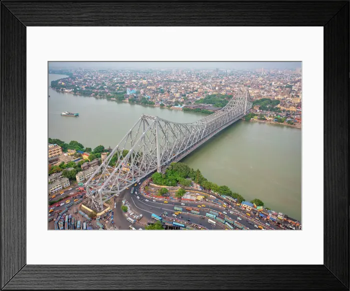 Framed Print : Aerial view of architectural landmark Howrah bridge or Rabindra Setu over the Hooghly River at day in Kolkata, West Bengal, India Framed Print : Aerial view of architectural landmark Howrah bridge or Rabindra Setu over the Hooghly River at day in Kolkata, West Bengal, India