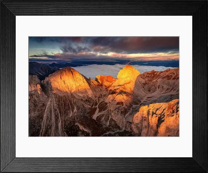 Framed Print : Dramatic cloudy sky and mist of autumn at dawn over Catinaccio (Rosengarten) and Roda De Vael, helicopter view, Dolomites, Italy