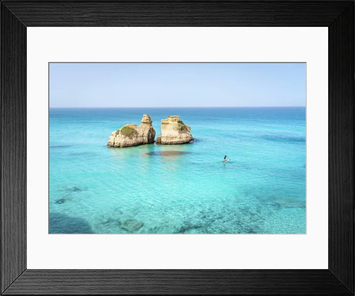 Framed Print : Aerial view of two rock formations in crystal-clear turquoise waters, located off the coast of Salento, Puglia, Italy. Two Sisters. Paddle boarding Framed Print : Aerial view of two rock formations in crystal-clear turquoise waters, located off the coast of Salento, Puglia, Italy. Two Sisters. Paddle boarding