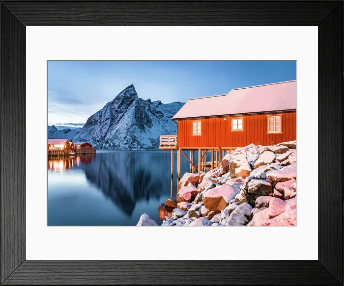 Framed Print : Snowy mountains and traditional rorbu reflected in the cold sea at dusk, Hamnoy, Reine, Lofoten Islands, Norway