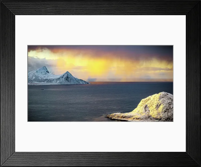Framed Print : Clouds in the burning sky at sunrise over snowcapped mountains and frozen fjord, Haukland, Vestvagoy, Lofoten Islands, Norway