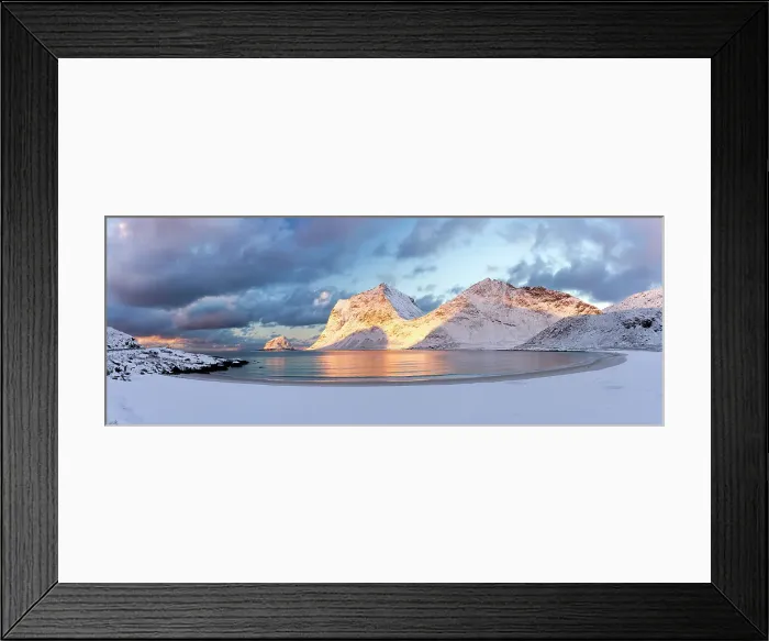 Framed Print : Panoramic of the snowy Haukland beach and mountains under colorful clouds at dawn, Vestvagoy island, Lofoten Islands, Norway