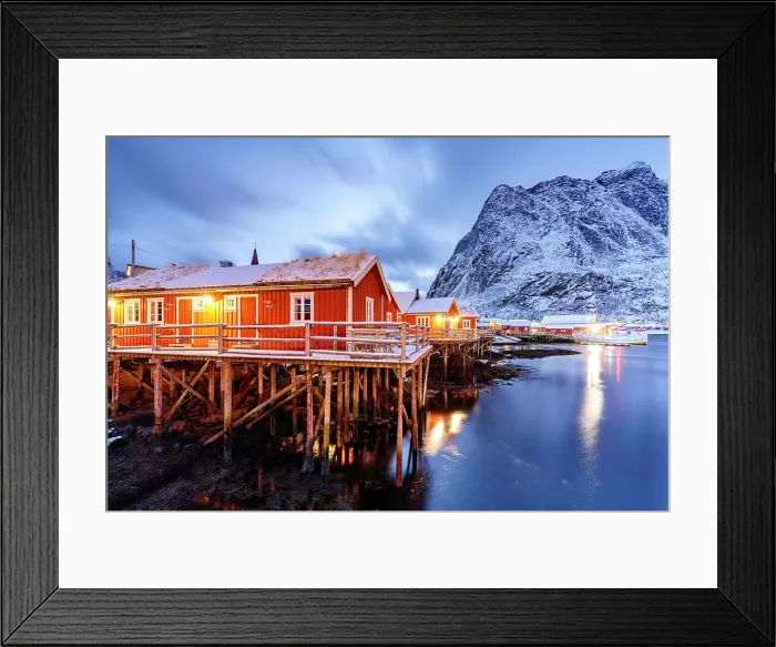 Framed Print : Fishermen huts framed by snowcapped mountains reflected in the icy sea at dusk, Reine, Lofoten Islands, Norway Framed Print : Fishermen huts framed by snowcapped mountains reflected in the icy sea at dusk, Reine, Lofoten Islands, Norway