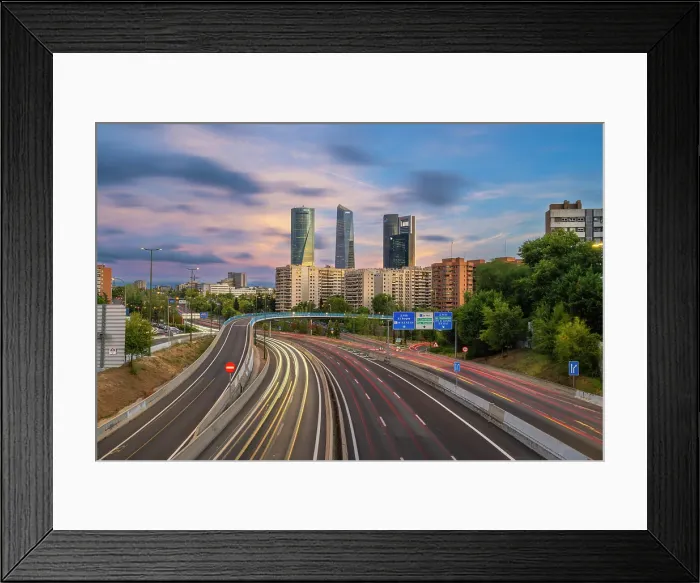 Framed Print : Car light trails on urban highway with Four Towers Business district in Paseo de la Castellana, Madrid, Spain Framed Print : Car light trails on urban highway with Four Towers Business district in Paseo de la Castellana, Madrid, Spain
