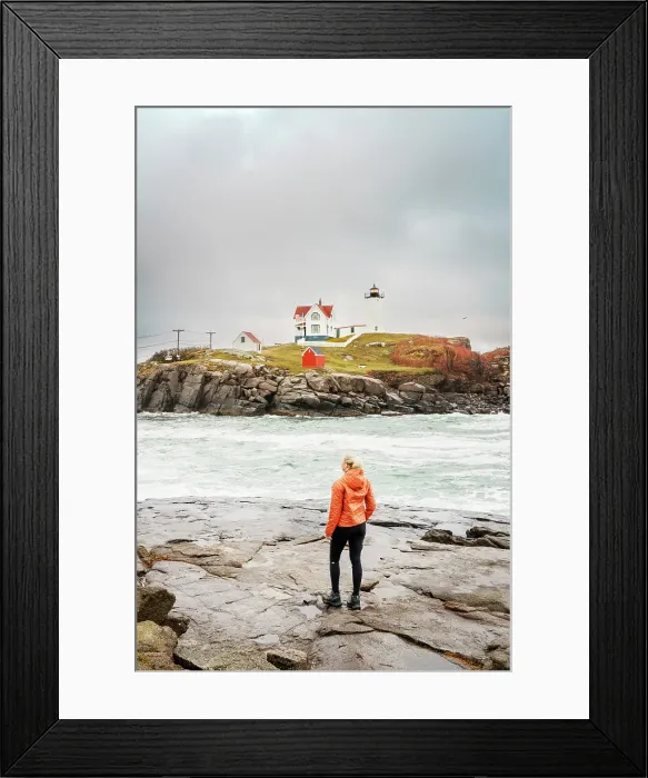 Framed Print : Woman enjoying the view of Cape Neddick Lighthouse also called Nubble Lighthouse, York, Maine, New England, USA