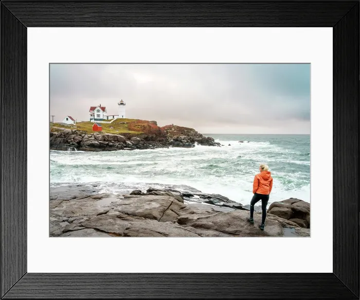 Framed Print : Woman enjoying the view of Cape Neddick Lighthouse also called Nubble Lighthouse, York, Maine, New England, USA