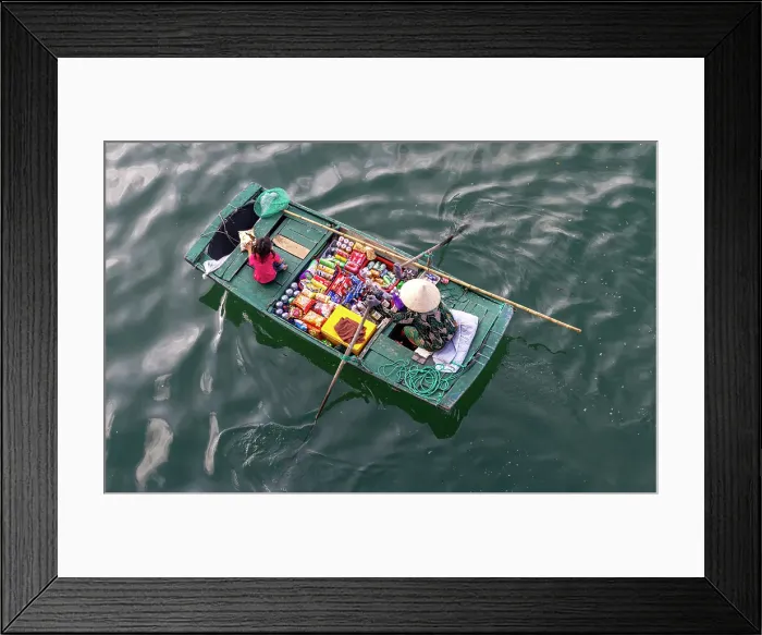 Framed Print : Woman selling snacks from her boat to tourists, Halong Bay, North Vietnam