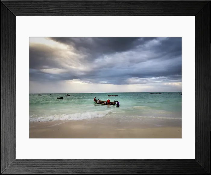 Framed Print : Local fishermen heading out to sea on an open wooden boat, Nungwi, Zanzibar, Tanzania Framed Print : Local fishermen heading out to sea on an open wooden boat, Nungwi, Zanzibar, Tanzania