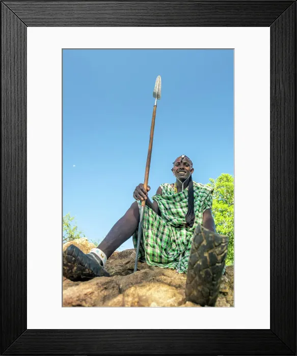 Framed Print : africa, Tanzania, Manyara Region. A maasai warrior sitting and showing his traditional motor bike sandals Framed Print : africa, Tanzania, Manyara Region. A maasai warrior sitting and showing his traditional motor bike sandals