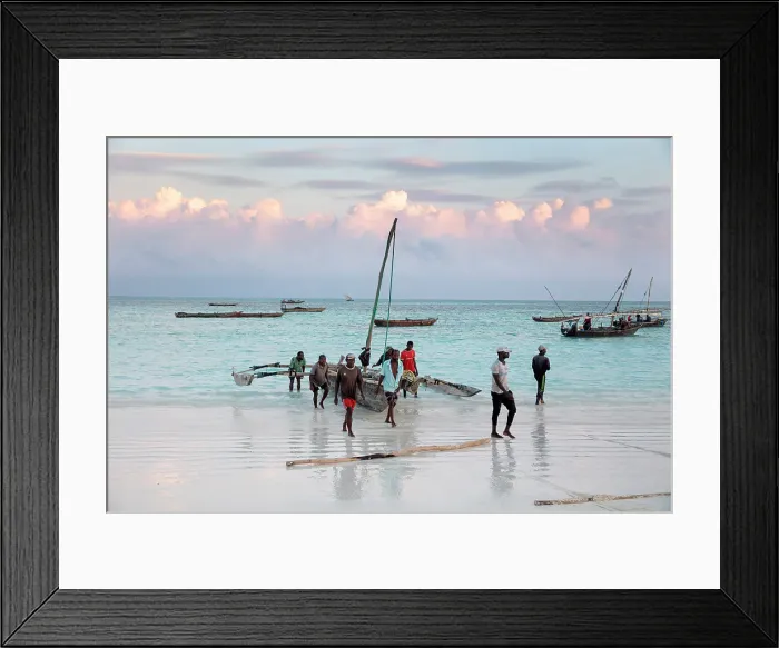 Framed Print : Local fishermen carrying their dhow up the beach, Nungwi, Zanzibar, Tanzania