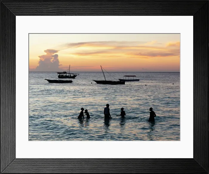 Framed Print : Local boys playing in the sea at sunset, Nungwi, Zanzibar, Tanzania