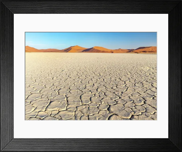 Framed Print : Cracked mud pan with towering sand dunes in the distance, Sossusvlei, Namib-Naukluft National Park, Namib Desert, Namibia Framed Print : Cracked mud pan with towering sand dunes in the distance, Sossusvlei, Namib-Naukluft National Park, Namib Desert, Namibia